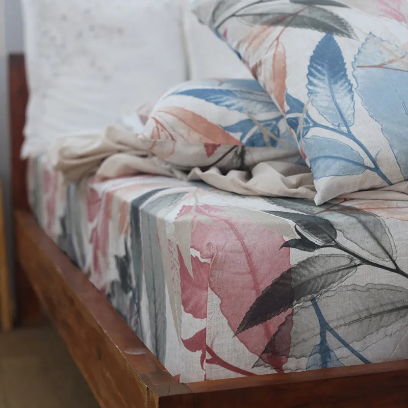 Close-up of the printed botanical duvet cover and matching pillow on a bed