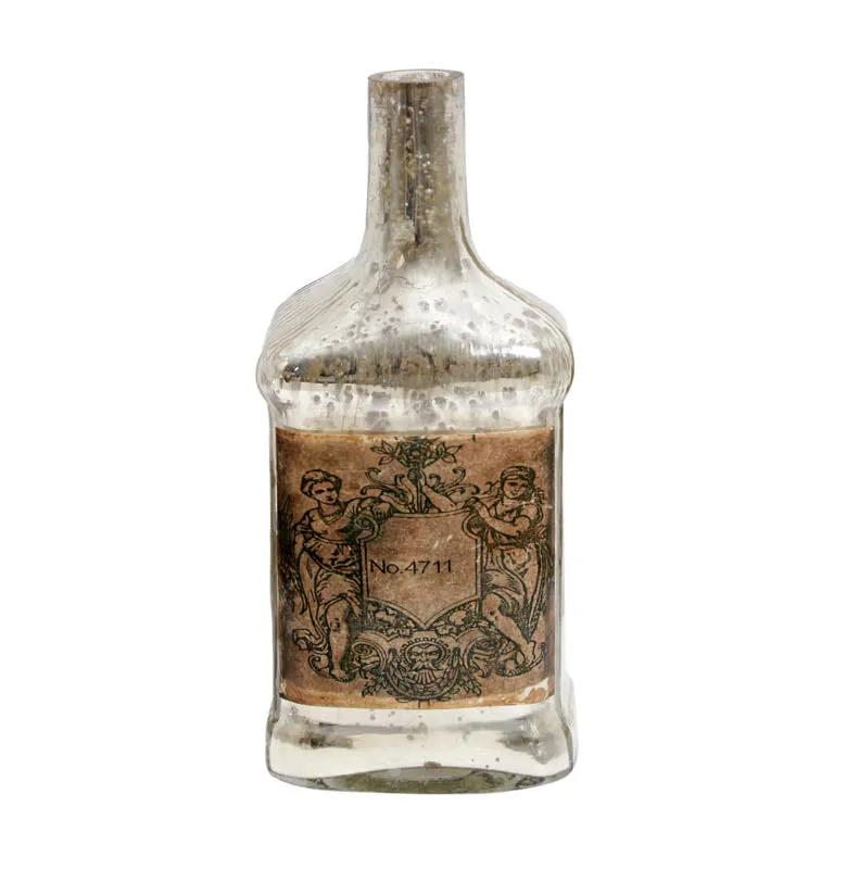 Front view of bottle-shaped glass vase with aged label detail