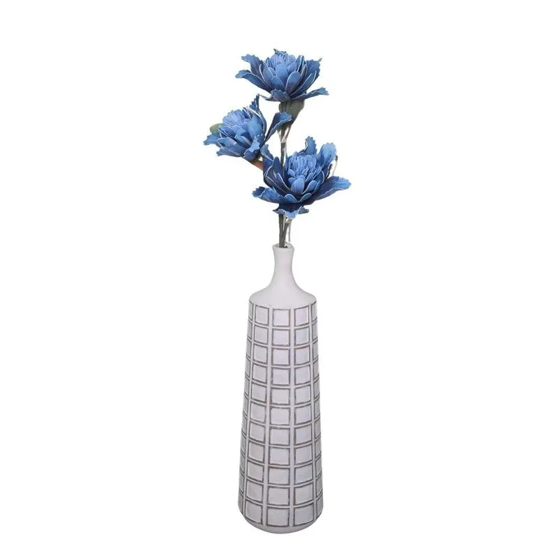 Full artificial dahlia stem with three blue flowers in a white vase.