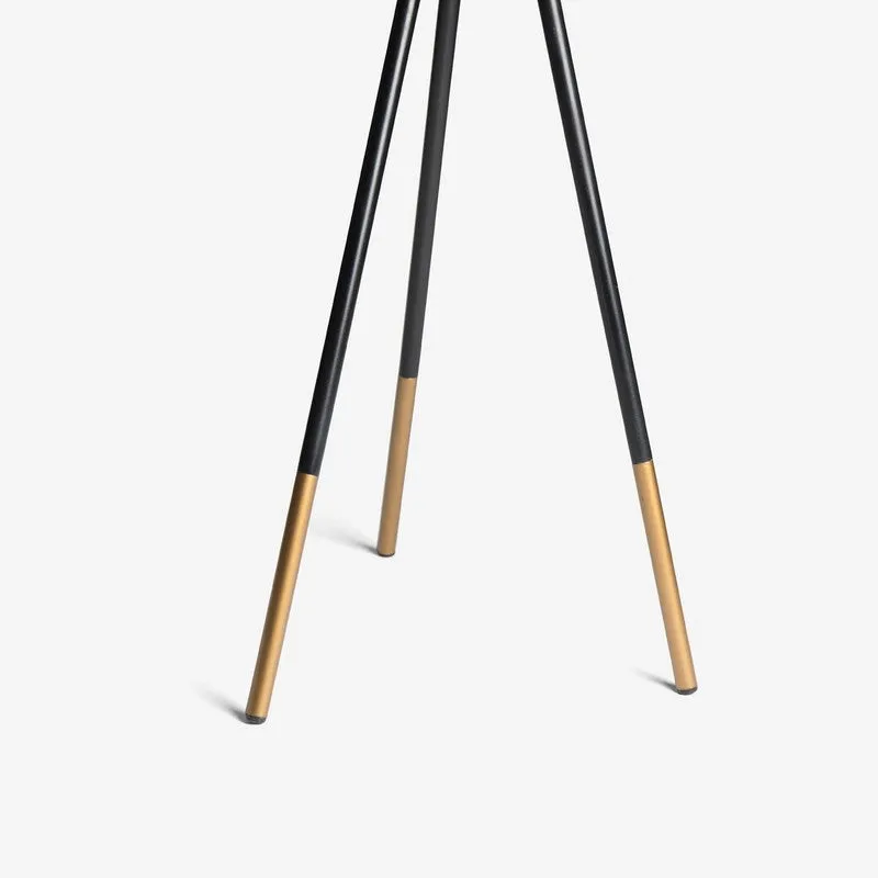 Close-up of tripod lamp legs with metallic gold-toned tips