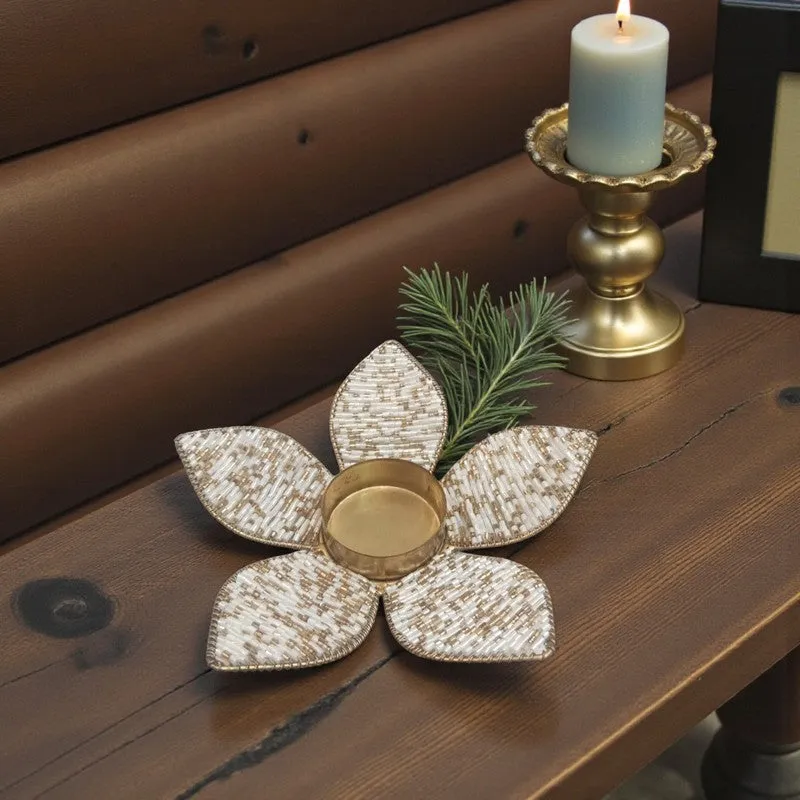Petal-shaped beaded tea light holder displayed on a dark wooden table