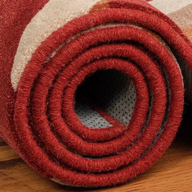 Rolled maroon carpet showing thickness and underside