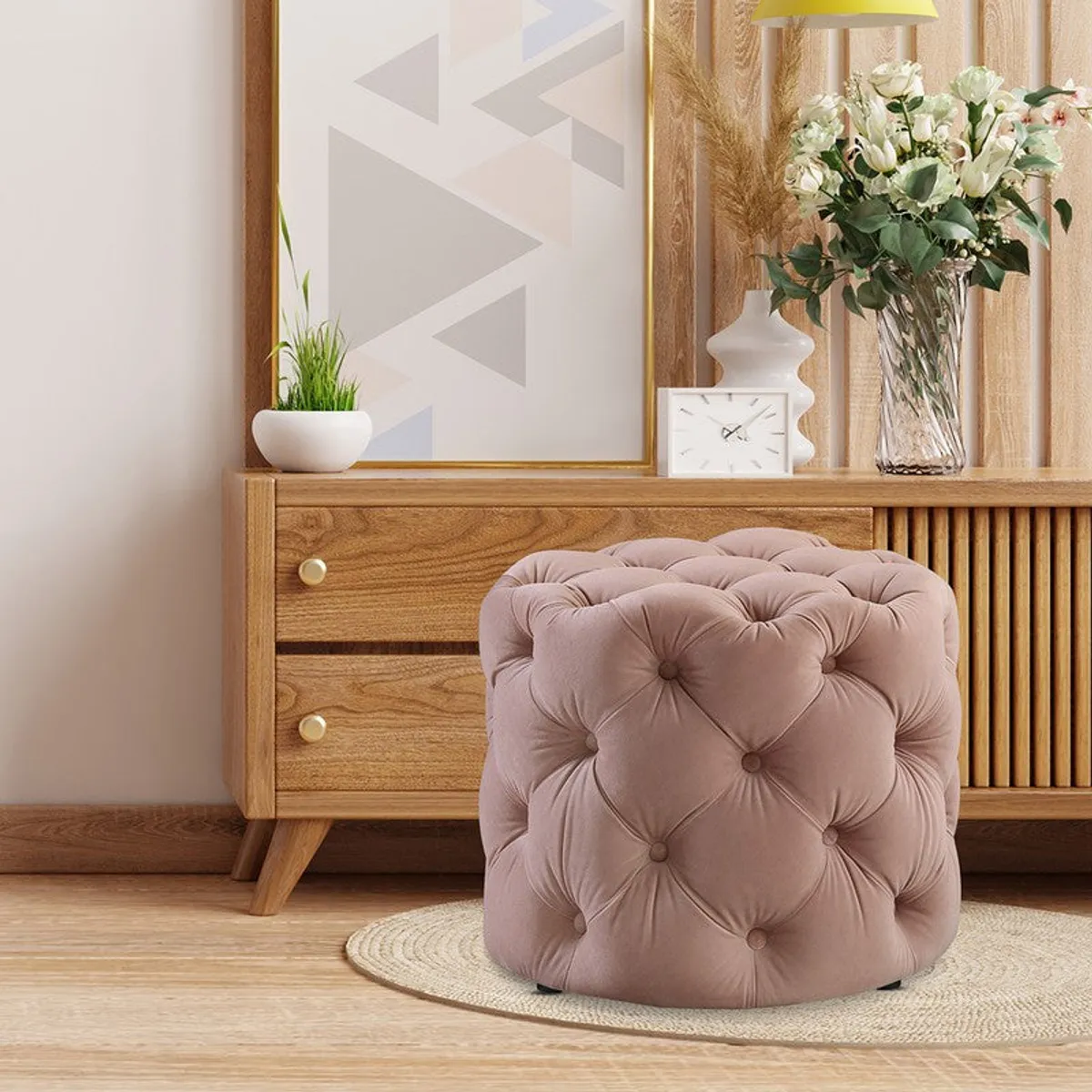 Pink tufted ottoman placed beside a wooden console