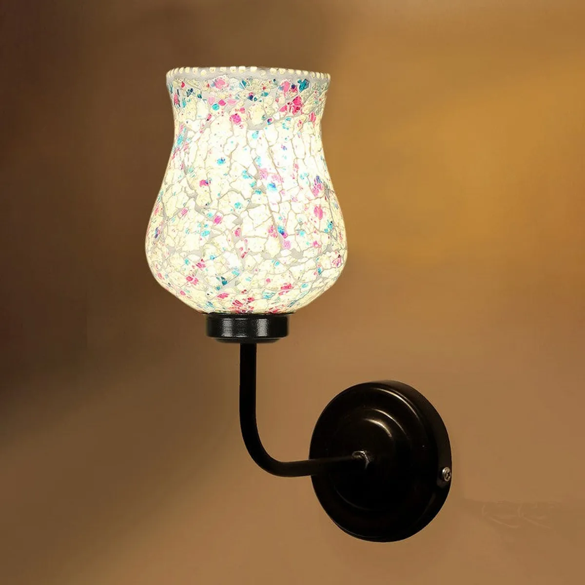 Close-up of illuminated mosaic glass shade on black wall mount