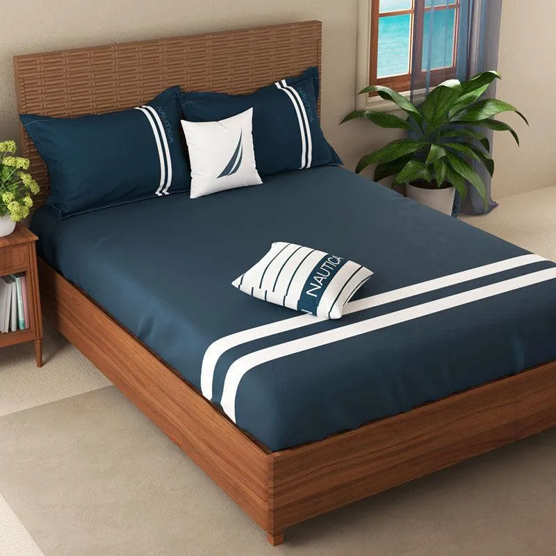Navy blue striped bedsheet and pillows styled on a double bed