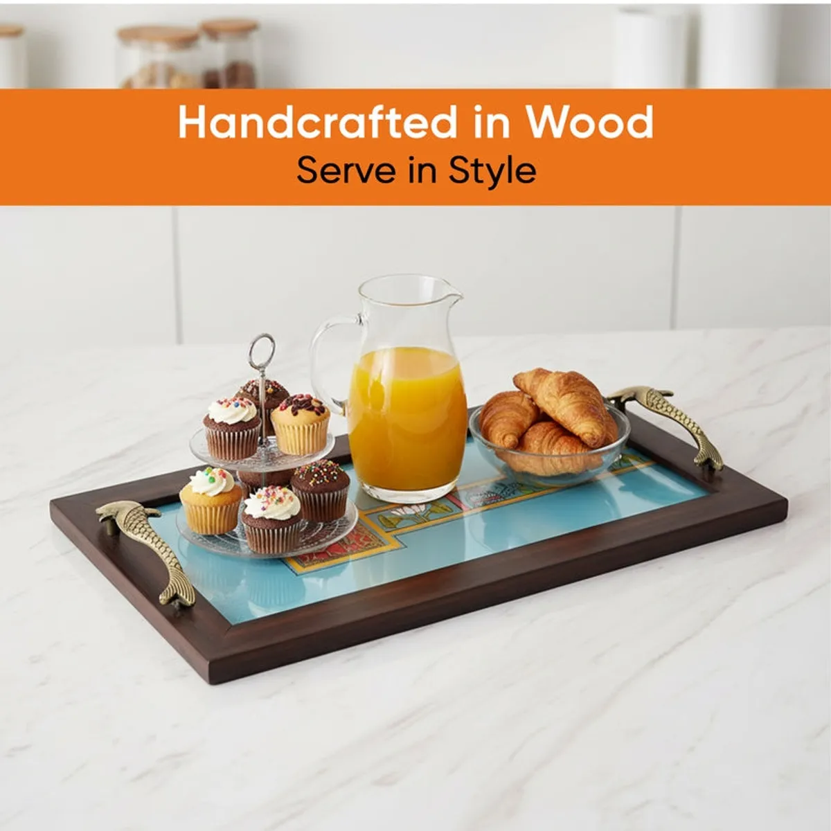 Blue serving tray styled with a jug and pastries on a dining table