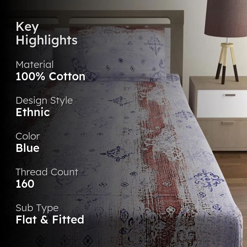 Blue and brown printed bedsheet on a bed in a styled bedroom