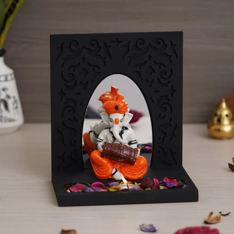 Front view of black rectangular tea light holder with musical Ganesha figurine