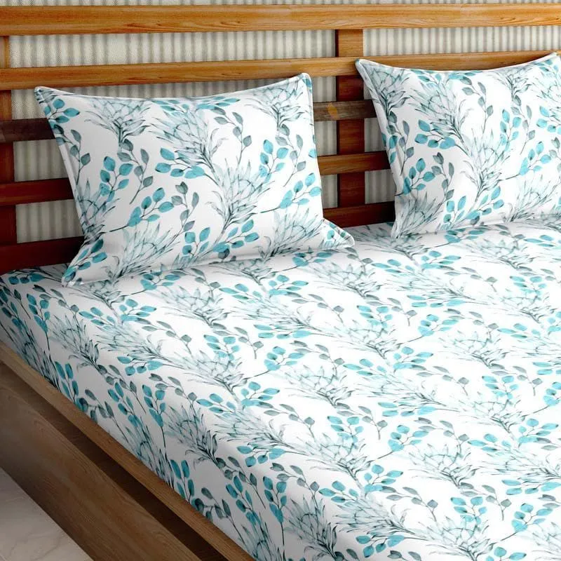 Queen bedsheet in white with blue botanical print styled on a wooden bed