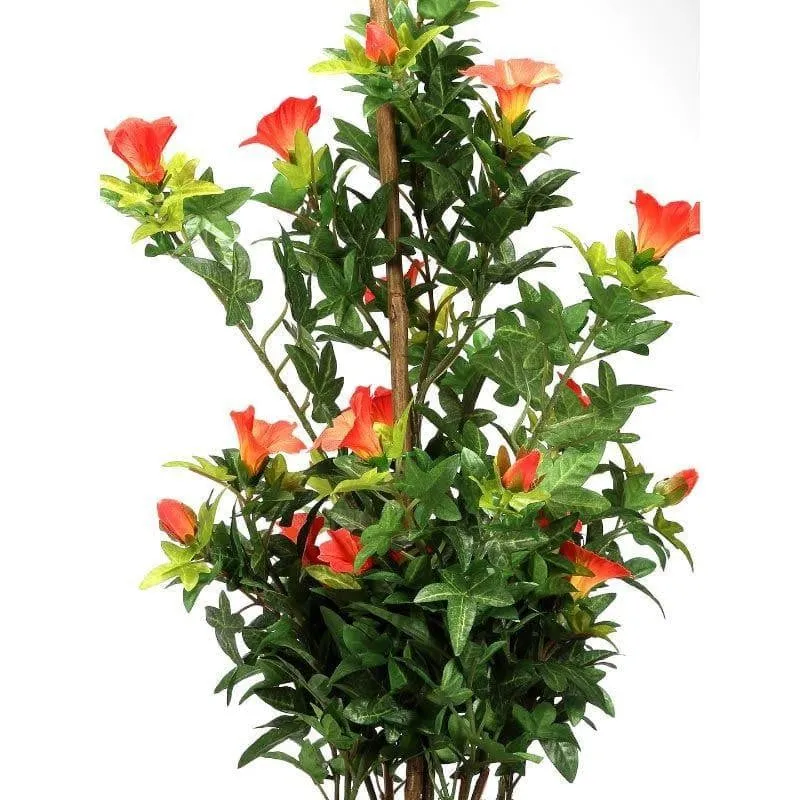 Close view of green artificial foliage and orange flowers on the faux bonsai