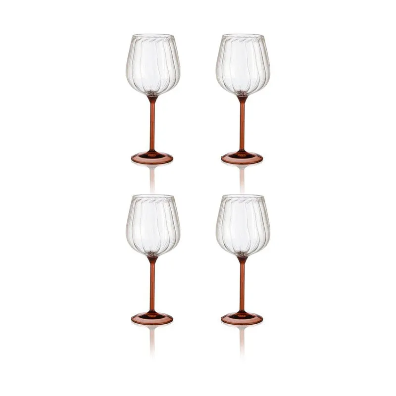 Two clear ribbed wine glasses with tawny stems arranged together