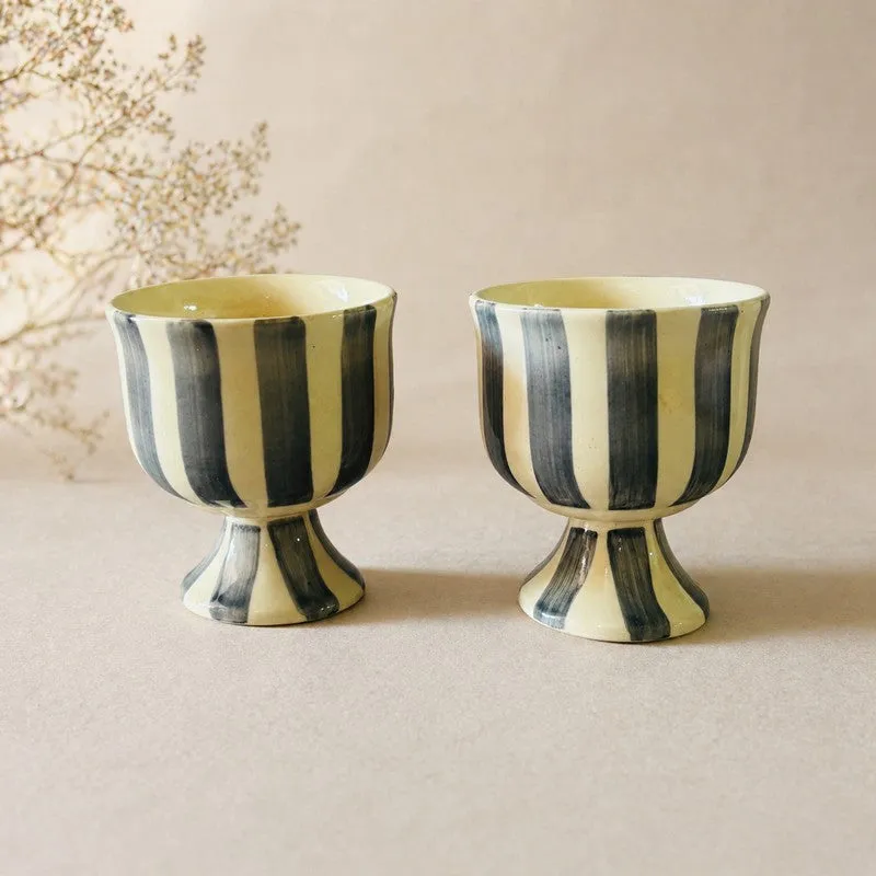 Set of two striped pedestal ice cream cups against a soft beige backdrop