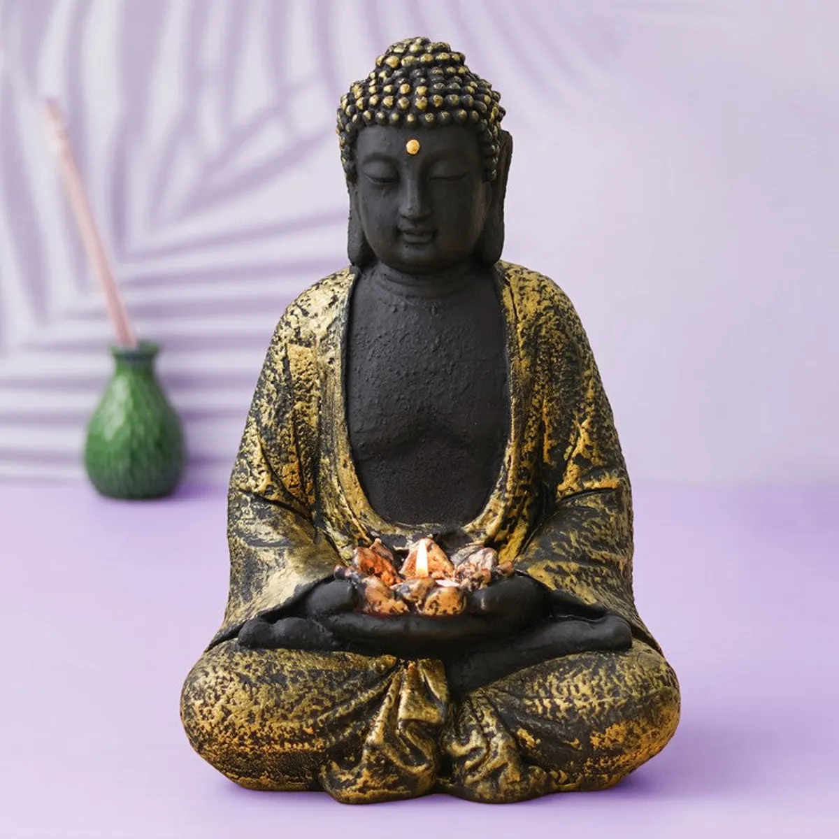 Front view of Buddha tea light candle holder with lit tea light