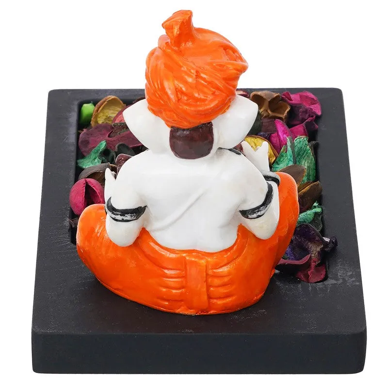 Rear view of Ganesha tea light holder showing orange and white figurine