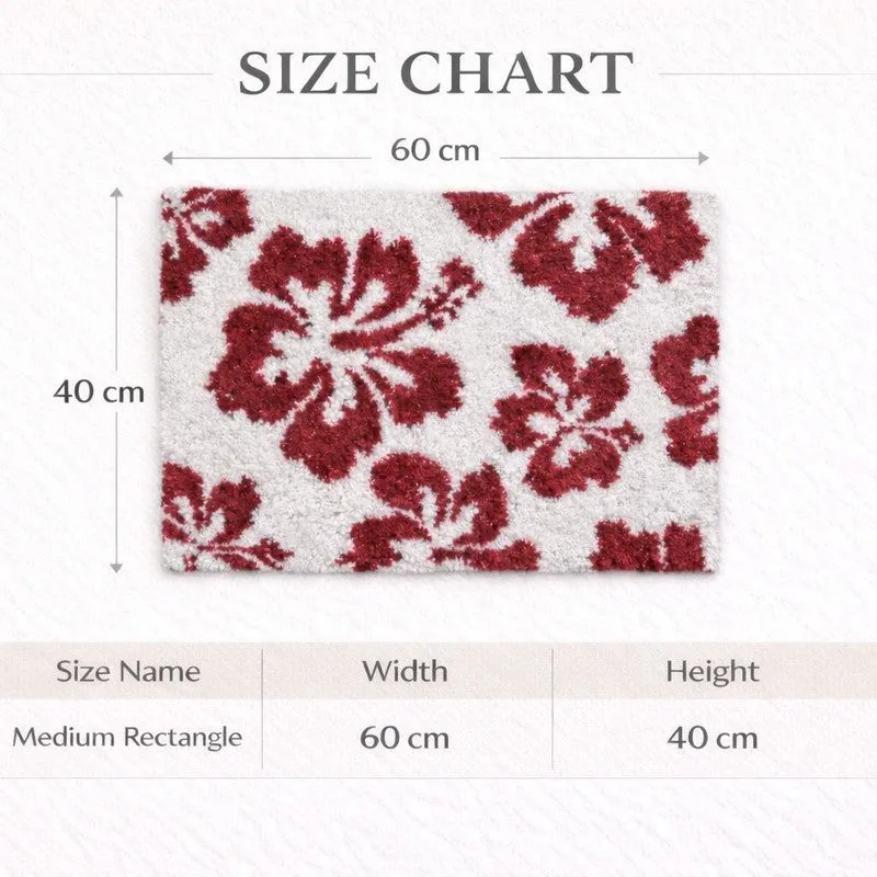 Red and white rectangular floral bath mat shown with size chart