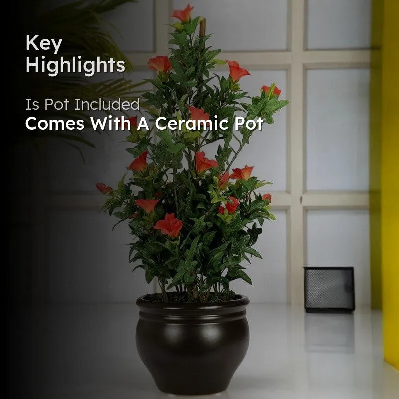 Faux flowering bonsai displayed in a ceramic pot indoors