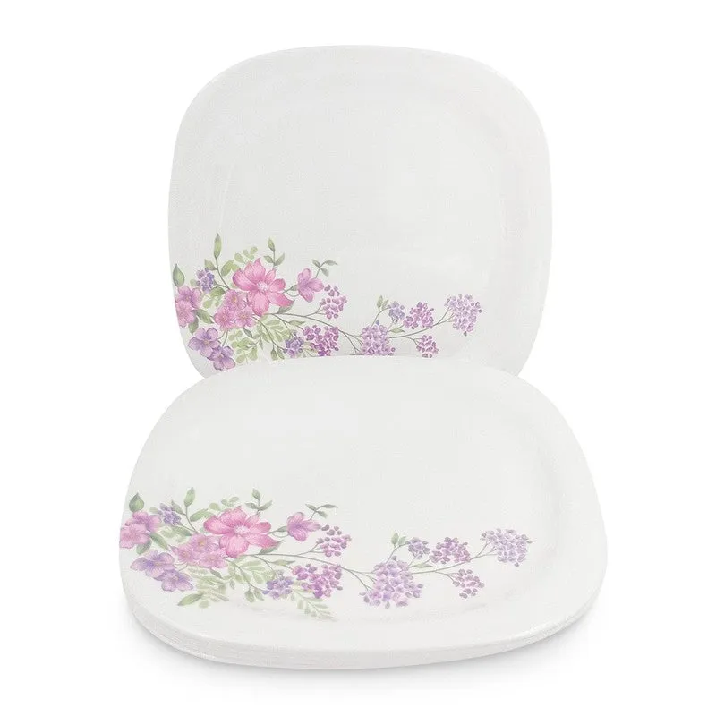 Two white square dinner plates with pink and lilac floral detailing