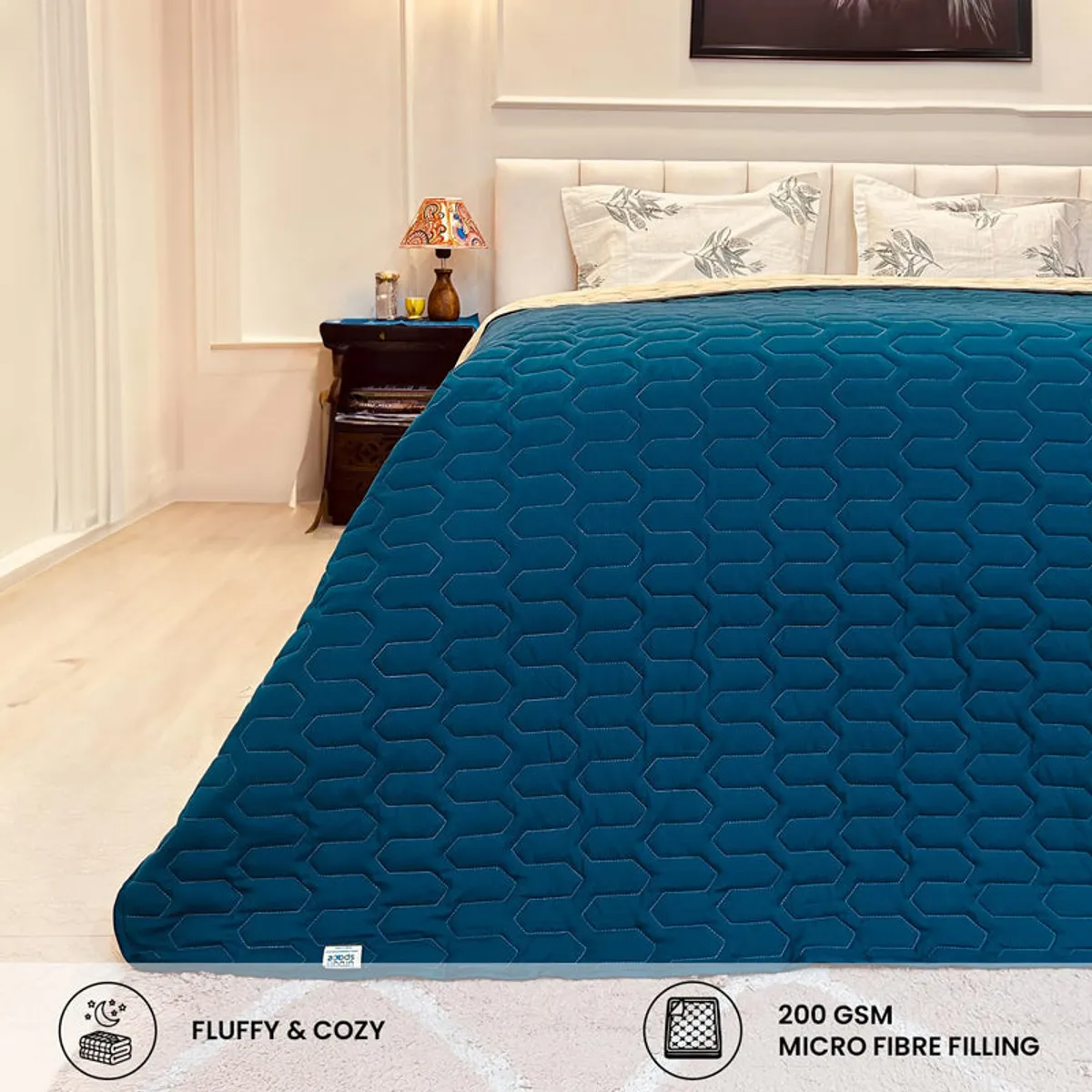 Close bedroom view showing the teal geometric quilted comforter.
