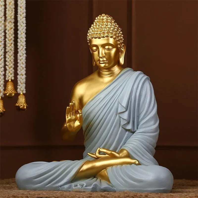 Three-quarter view of seated Buddha idol in grey and gold