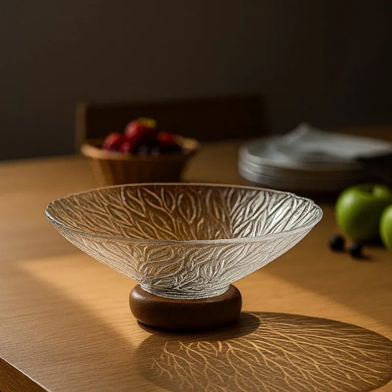 Close view of a transparent glass fruit bowl with botanical surface detailing