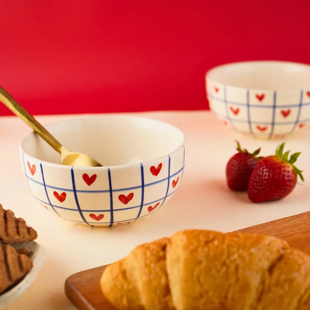 Heart grid bowl styled with spoon, strawberries and pastries