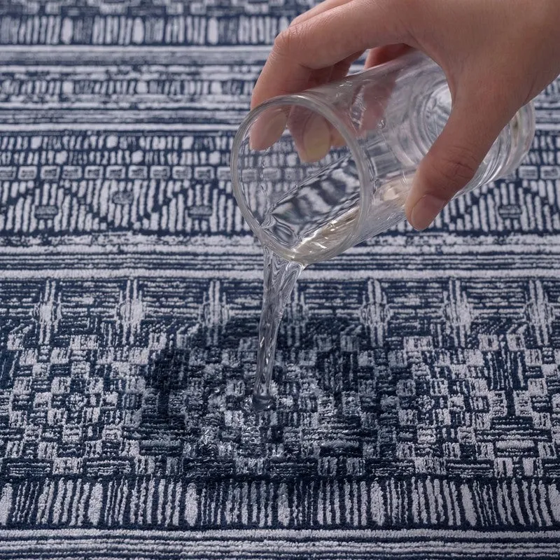 Close-up of water being poured onto the blue bath towel surface