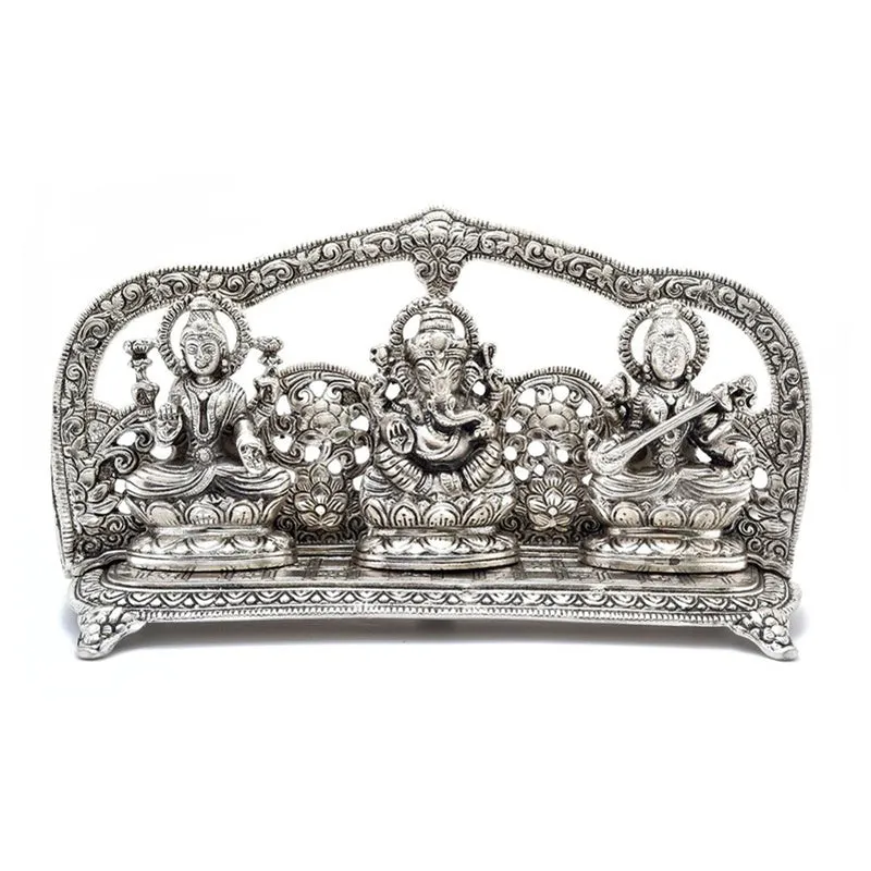 Studio front view of the silver-toned Lakshmi Ganesha Saraswati metal idol