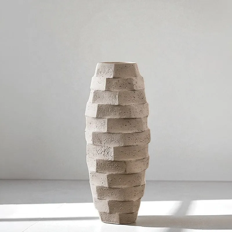 White textured geometric vase placed on a sunlit surface