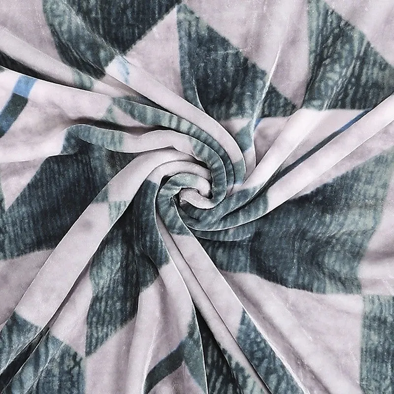 Close-up of pink and green blanket fabric gathered in folds