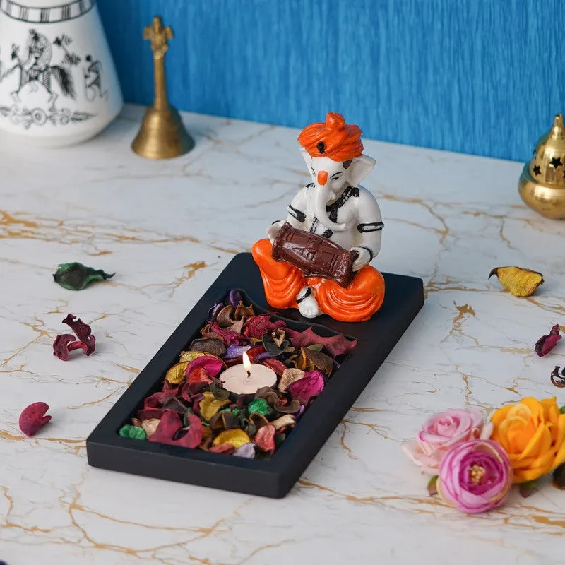 Ganesha tea light holder styled on a tabletop with a lit candle
