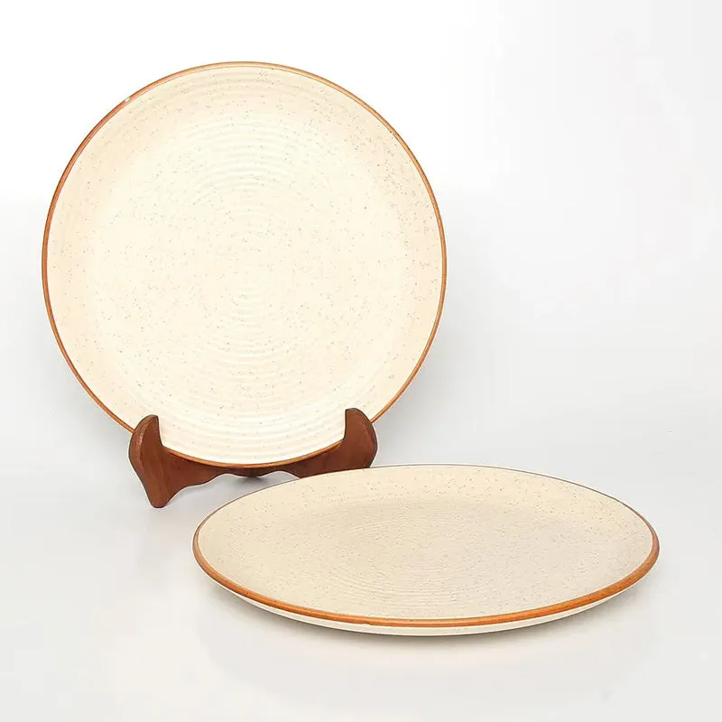 Two ceramic quarter plates in white with a warm brown rim