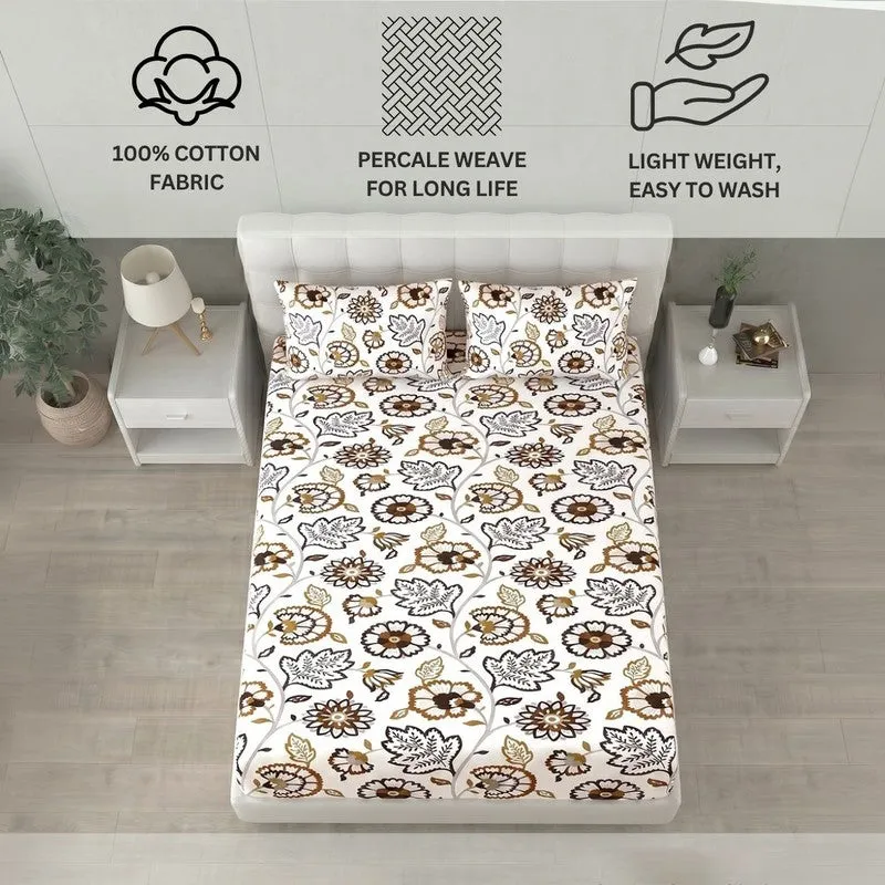 White and brown floral bedsheet displayed on a bed with matching pillow covers