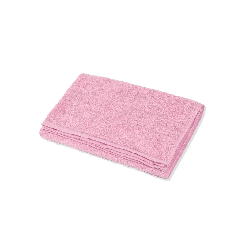 Folded light pink bath towel on a white background