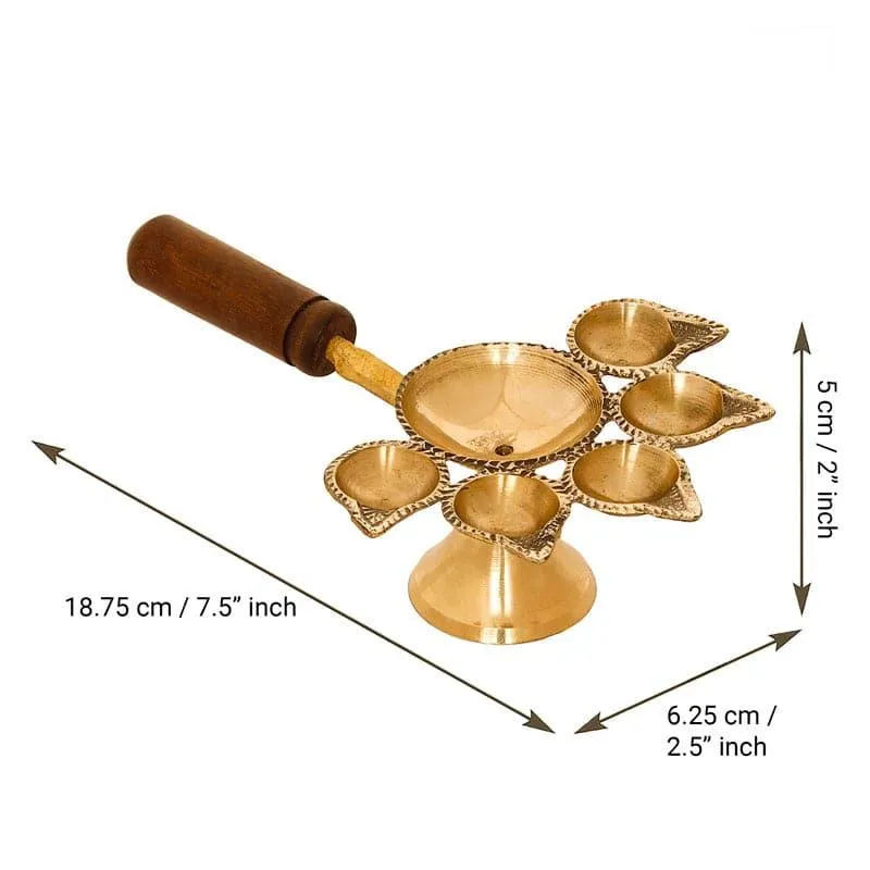 Gold-toned panchdeep diya with a brown wooden handle shown against a white background