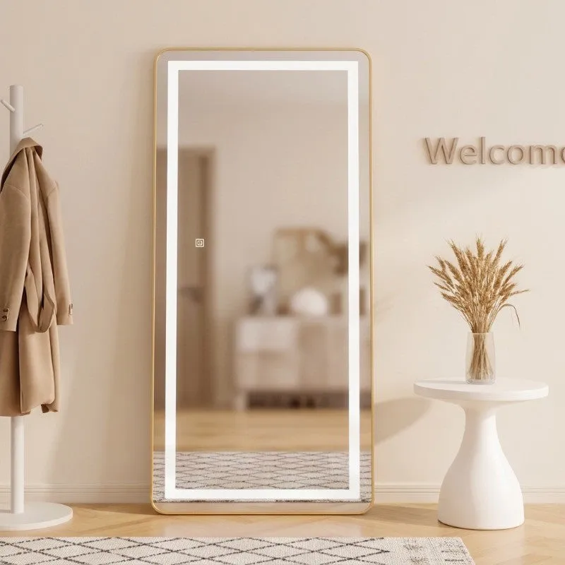 Gold-framed LED mirror in a bright entryway with a coat stand