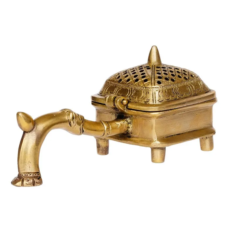 Angled view of gold brass incense holder with curved handle