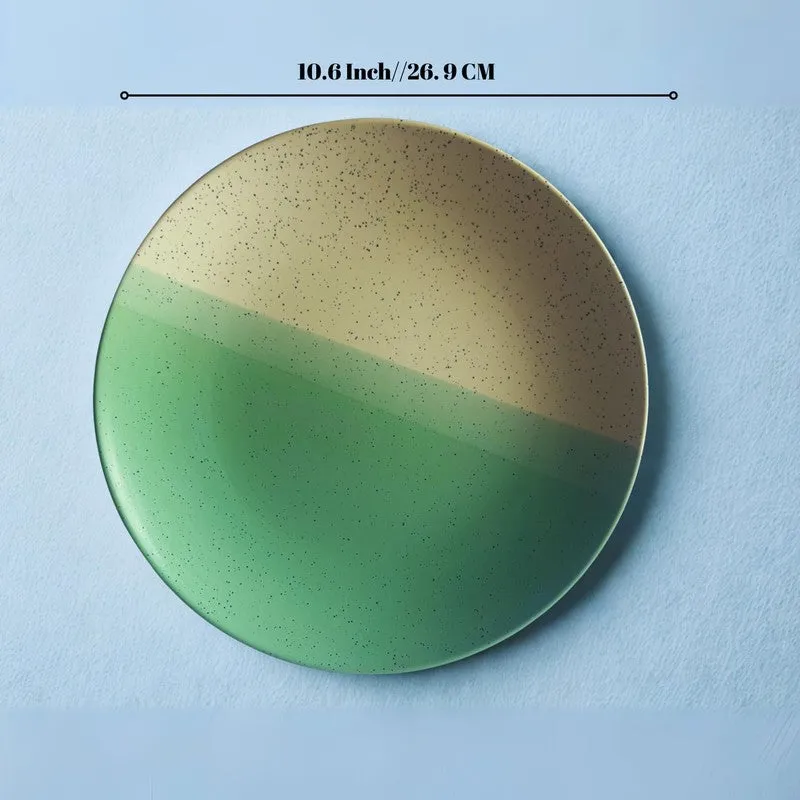 Green and beige ceramic dinner plate shown from above