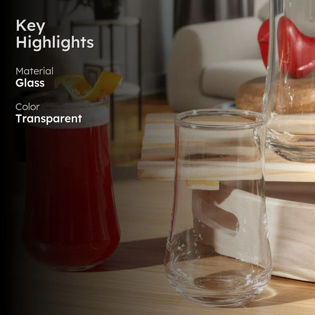 Clear glass tumbler beside a red drink in a styled indoor setting