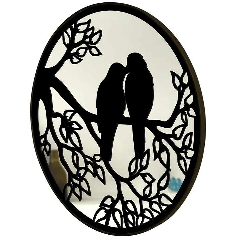 Angled side view of round black decorative bird wall mirror