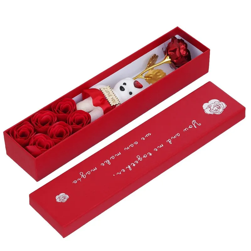 Open red rectangular gift box with decorative items inside