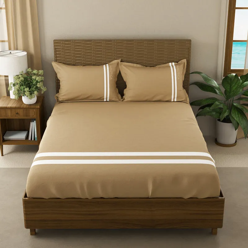 Front view of tan and white striped bedsheet set on a bed
