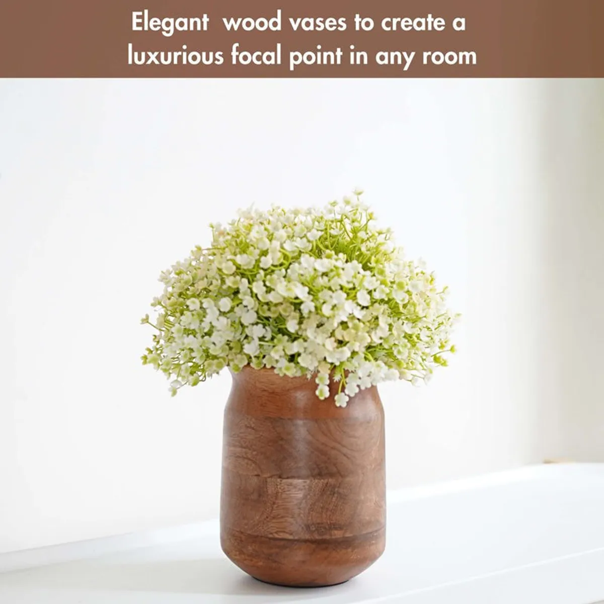 Dark brown wooden vase with a dense bunch of small white flowers