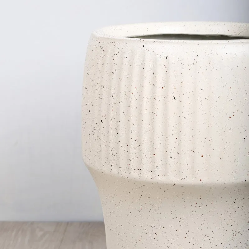 Close-up of the white planter's ribbed, speckled surface