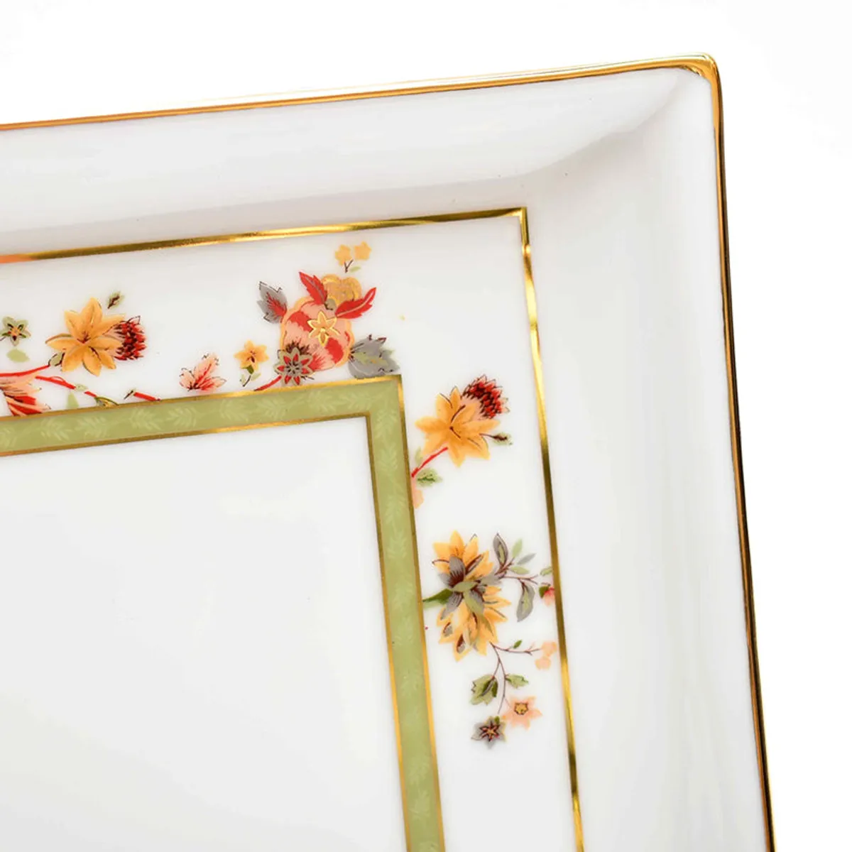 Close-up of floral porcelain platter border with green and gold trim