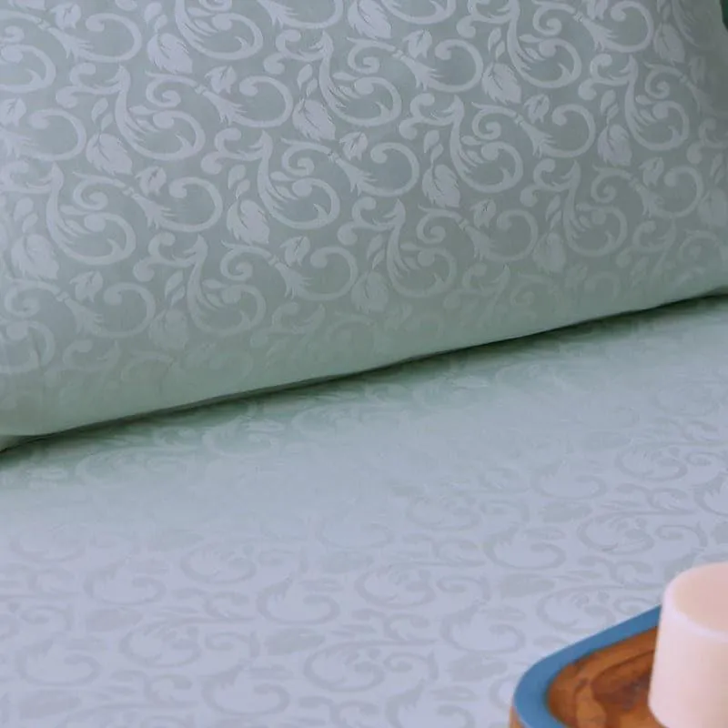 Detailed view of the damask pattern on the ice blue bedsheet