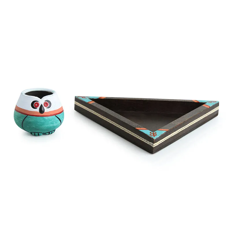 Owl-shaped toothpick holder beside a black triangular serving tray
