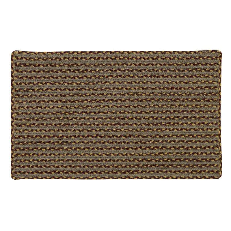 Rectangular brown woven bath mat with narrow geometric stripe pattern