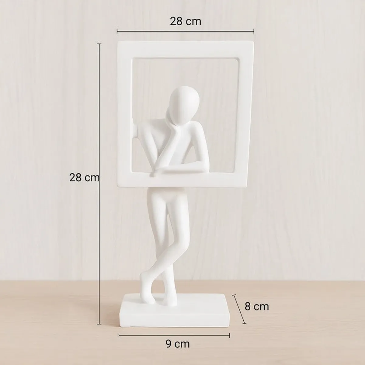 White resin figurine sculpture shown with its square frame and base