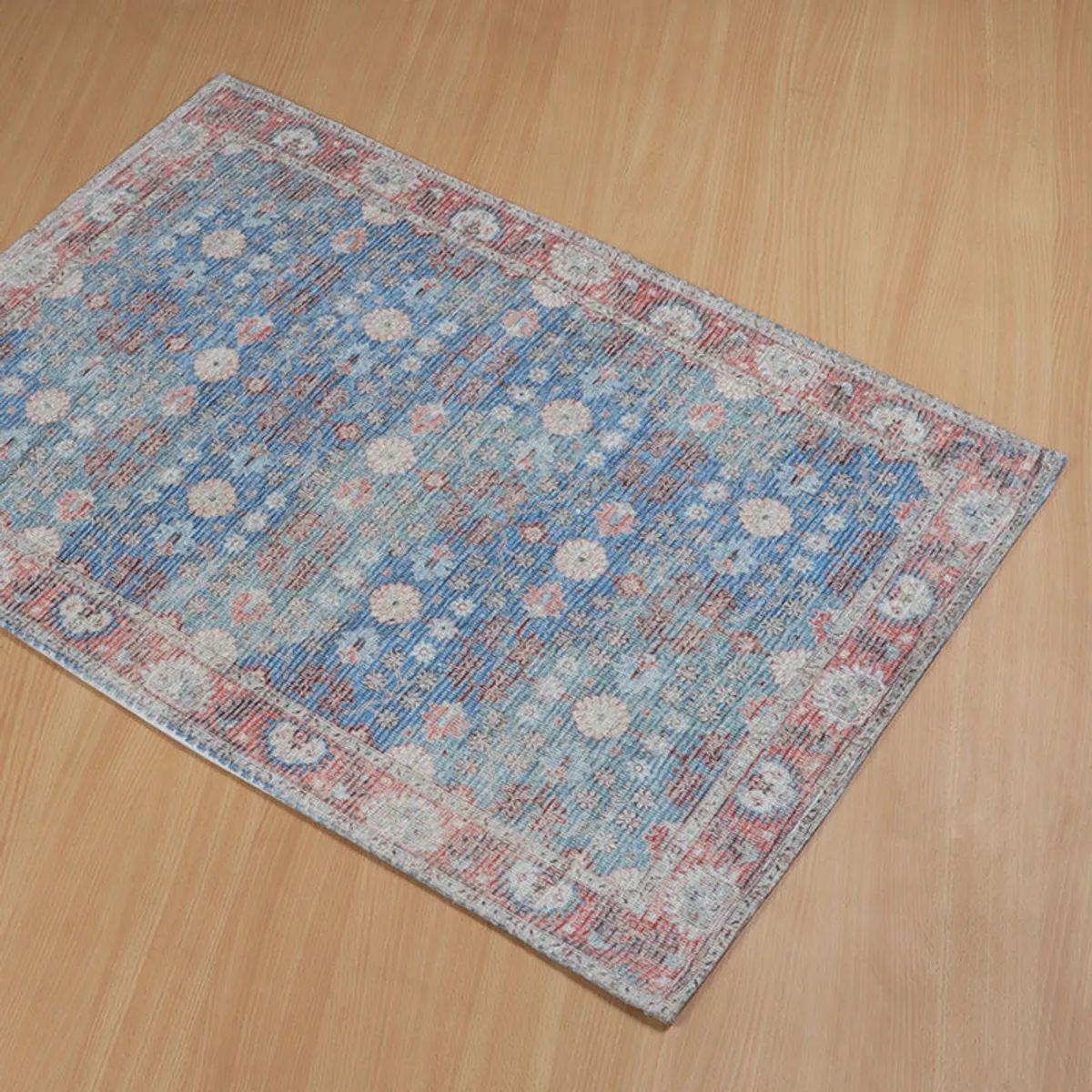 Top view of a rectangular mat with a blue centre and ornate patterned border.