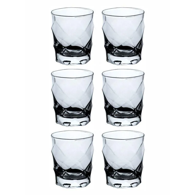 Set of six transparent faceted glass tumblers on a white background